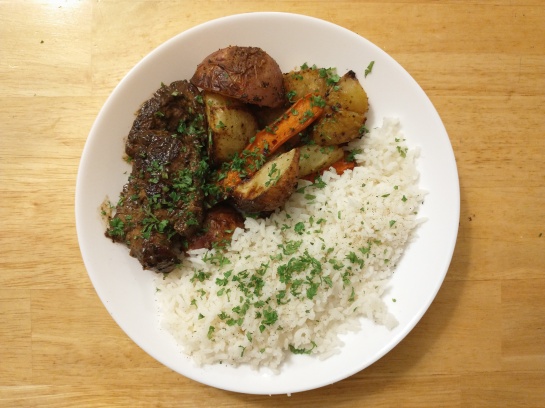 Seared sirloin steak with Dijon-cornichon pan sauce and roasted potatoes, beets and carrots served with white rice, garnished with chervil.
